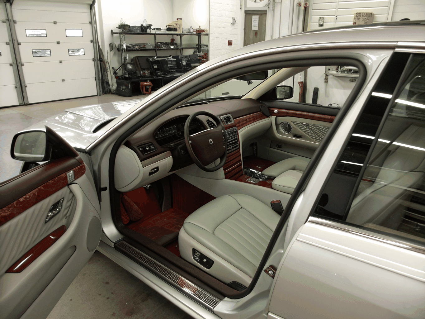 Vehicle cockpit dashboard and leather seats being detailed with clean microfiber tools